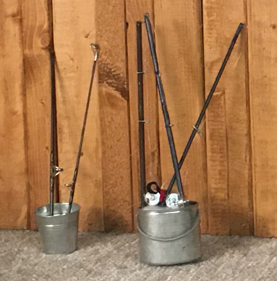 ice fishing poles in a bucket