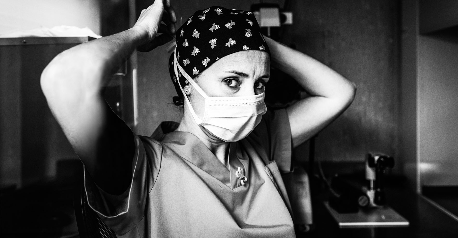 Confident nurse staring into the camera as she prepares for surgery