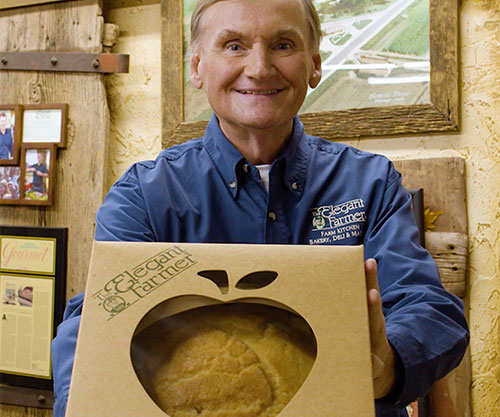 Elegant Farmer owner holding an apple pie