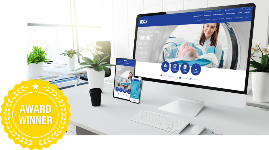 Beaver Dam Community Hospital website displayed on desktop, tablet and phone on a desk and labeled award winner