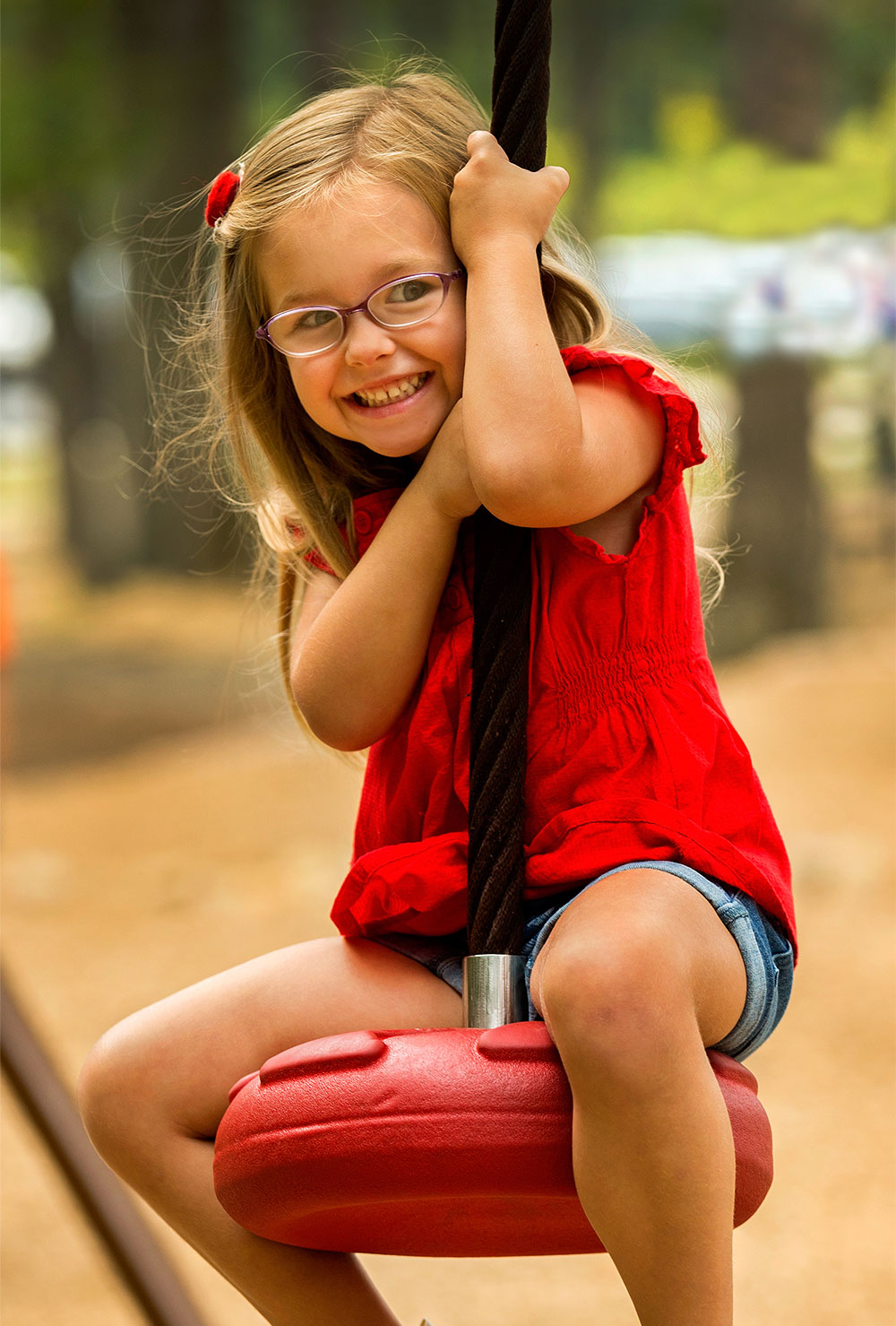 young, smiling girl at a playground — fitness marketing work